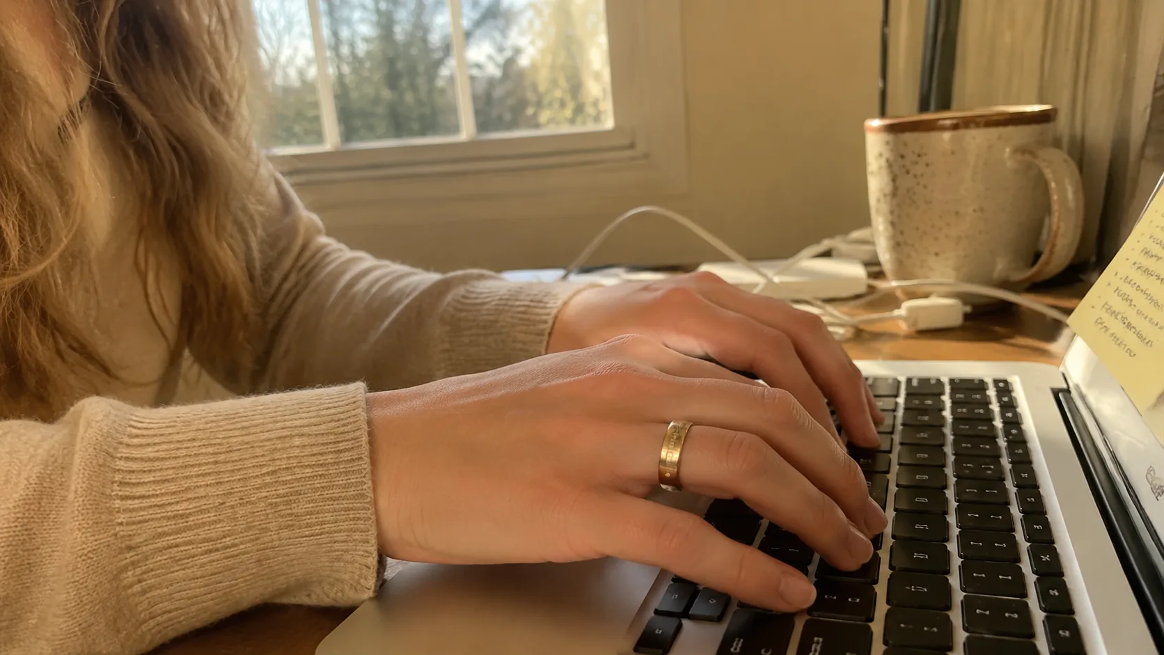 Woman wearing a smart ring during a home wellness routine