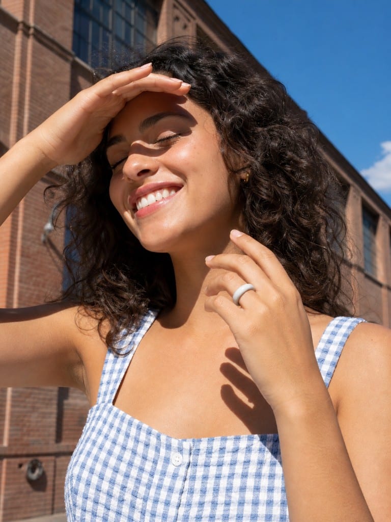 Woman smiling in sunlight in the city